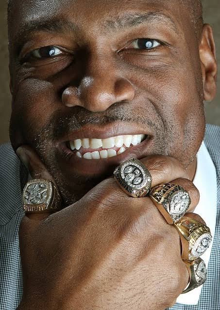 Charles Haley smiling and showing his championship rings
